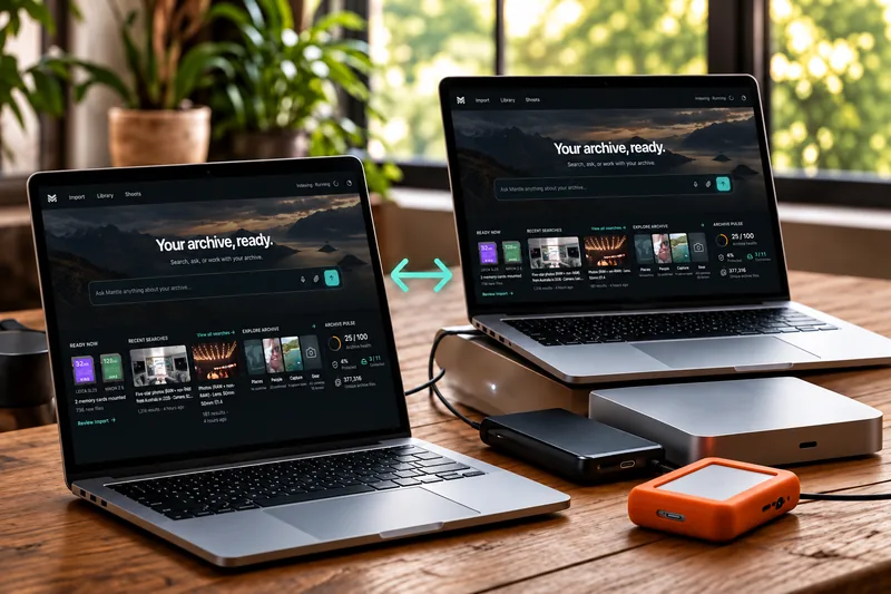 Two MacBooks displaying Mantle archive Home with a mint sync arrow between them and external backup drives on a wooden desk.